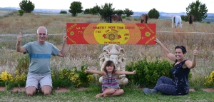 Richard and Vidya hold the painted version of the mantra in the garden at Suryalila, Spain